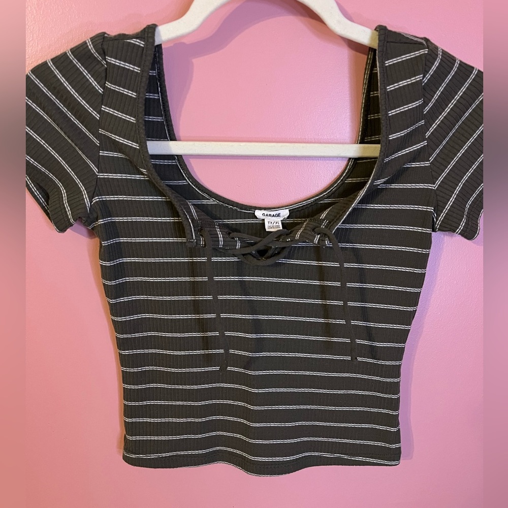 Green and white stripped baby tee with a lace up front. Size XS fits a S
